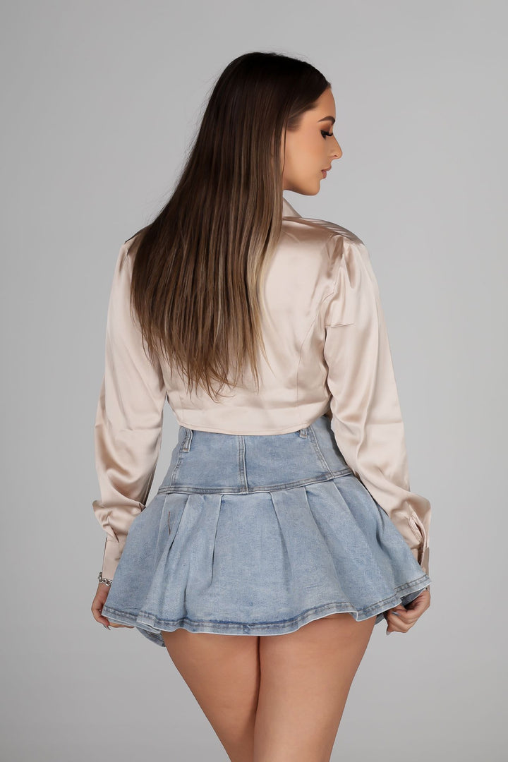 Long sleeve satin blouse featuring a collared neckline and mid rise cropped fit