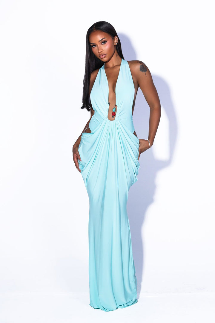 Deep plunging V front halter neck dress featuring bold side cut out at the midriff with U ring hardware detail at center front, Fitted through the hip with draped ruching that pools into the skirt