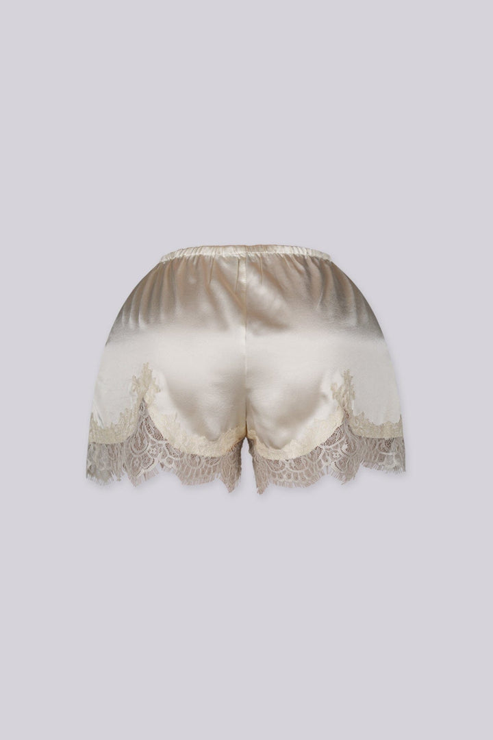 Silky elastic-waist shorts with a soft draped finish
Delicate lace trim hem adds a subtle feminine edge