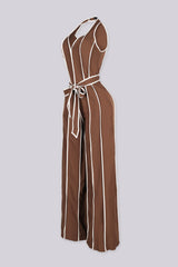 Wide leg halter jumpsuit with a plunging V neckline featuring waist tie