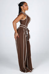 Wide leg halter jumpsuit with a plunging V neckline featuring waist tie