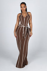Wide leg halter jumpsuit with a plunging V neckline featuring waist tie