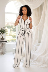 Wide leg halter jumpsuit with a plunging V neckline featuring waist tie