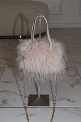 EDGE — natural faux fur mini bag displayed on a stand, front view flat lay