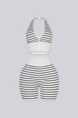 Plunging halter neckline with a half zip closure down the center front, Matching mid length biker shorts designed with a white fold over waistband