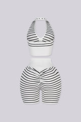 Plunging halter neckline with a half zip closure down the center front, Matching mid length biker shorts designed with a white fold over waistband