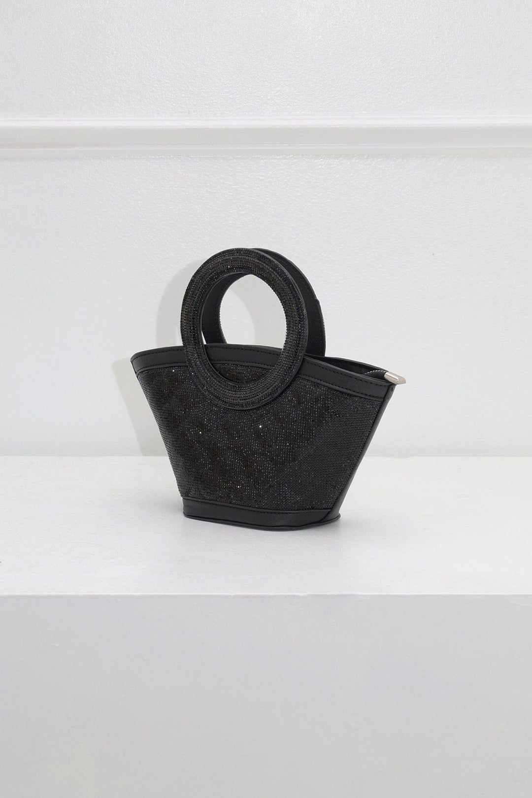 EDGE — black rhinestone-embellished top-handle bag, angled view flat lay