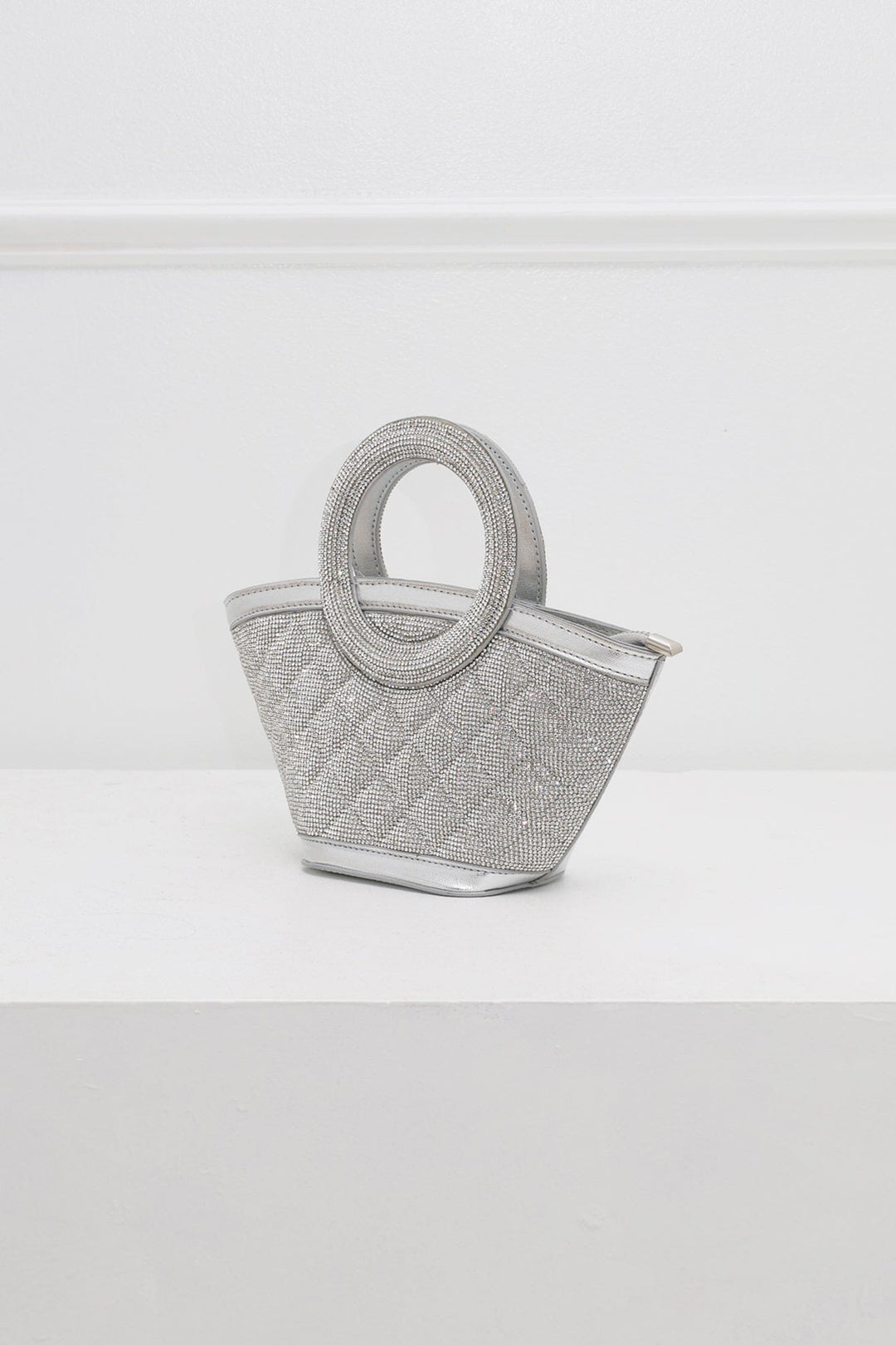 EDGE — silver rhinestone-embellished top-handle bag, angled view flat lay