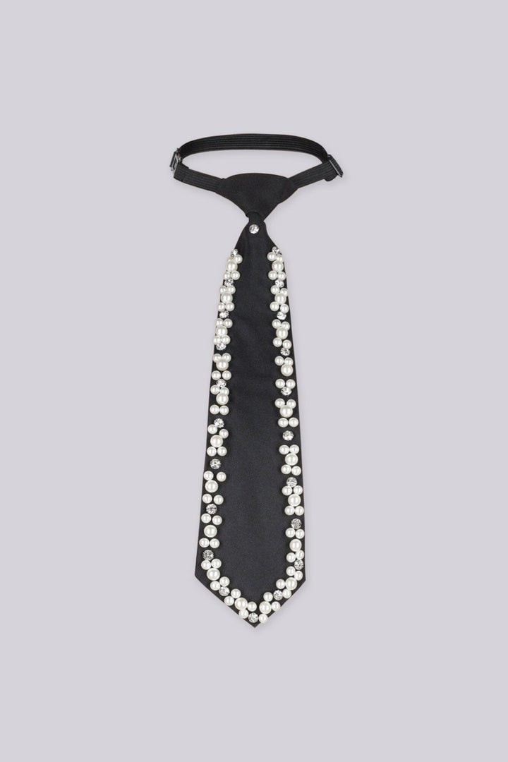 Black necktie embellished with pearls and rhinestones along the edges, flat lay