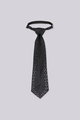 Black necktie with rhinestone stud detailing, close-up flat lay