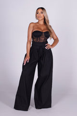 Strapless sheer lace corset jumpsuit with sweetheart bustier bodice 
High waisted wide leg featuring fitted waistband with drawstring tie at the center front