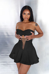 Faux leather corset tube mini dress with sweetheart neckline featuring center cutout with lace up and ruffle hem