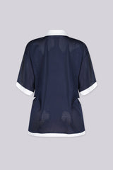 Oversized mesh jersey featuring v neck paired with a classic white fold-over polo collar