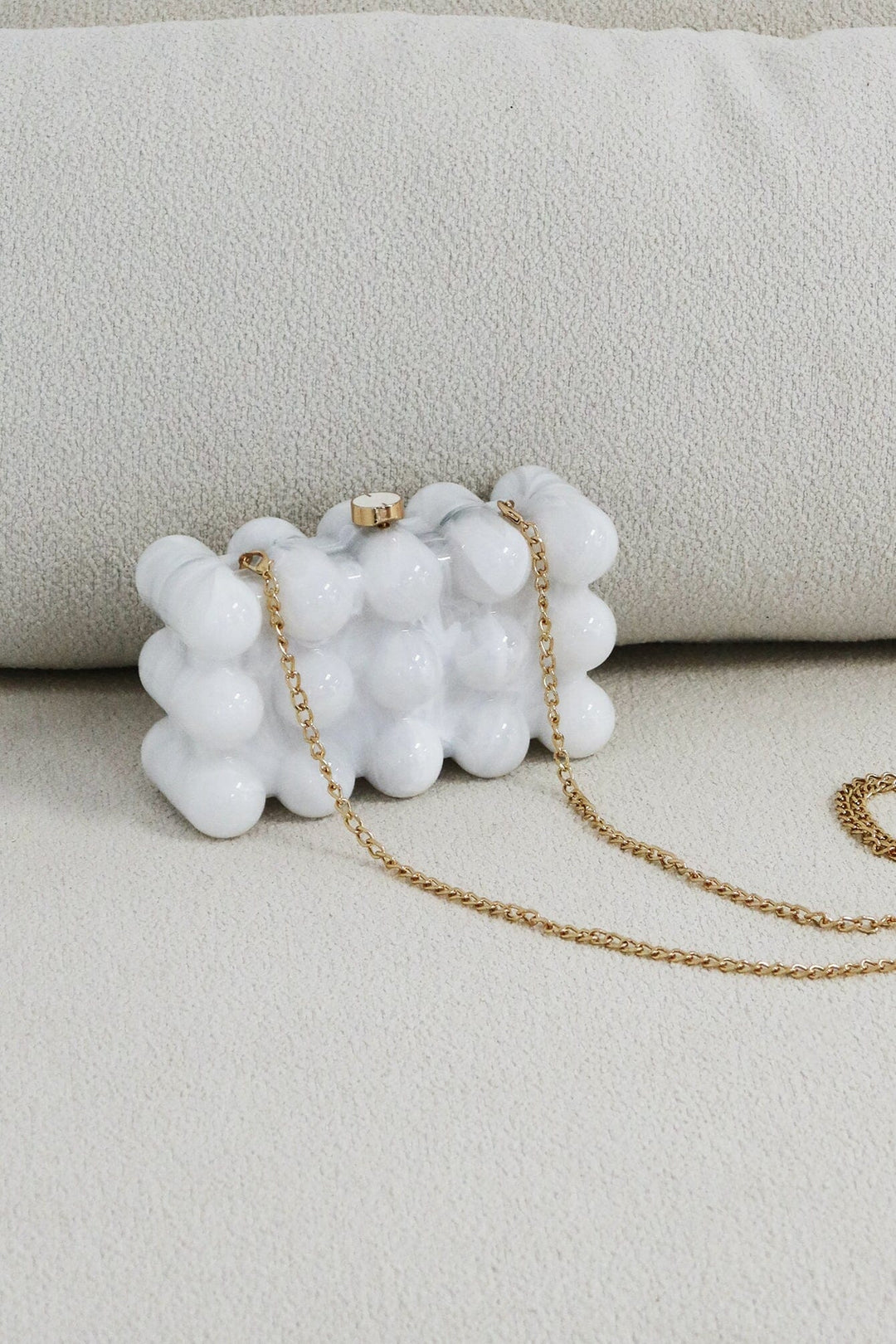 EDGE — pearl bubble-textured mini clutch, front view flat lay