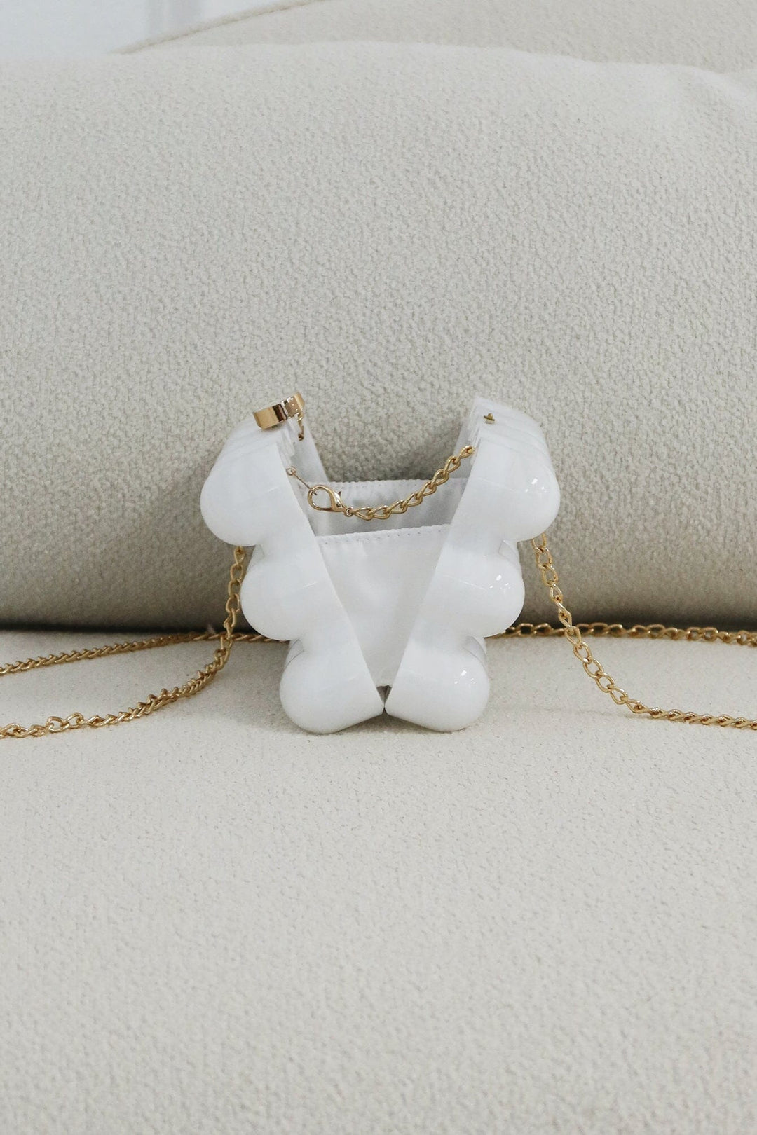EDGE — pearl bubble-textured mini clutch shown open from the back, flat lay