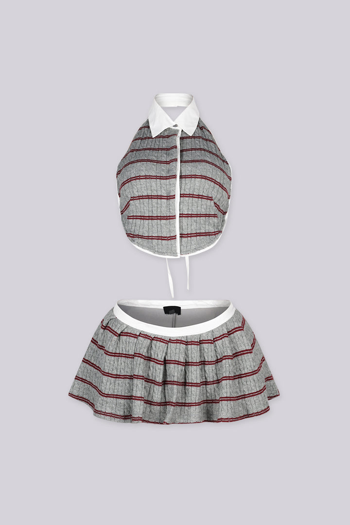Cropped collared halter top with button front closure Matching low rise pleated mini skirt with contrast waistband