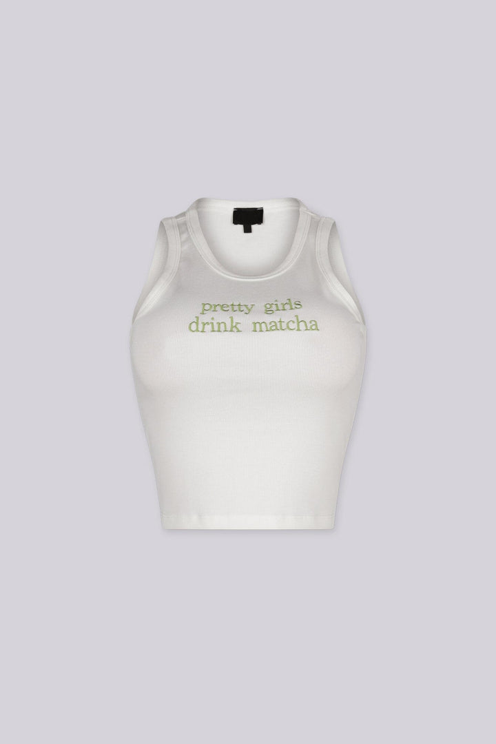 White ribbed tank top featuring "pretty girls drink matcha" embroidered graphic