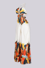 Halter neck jumpsuit featuring center O-ring with waist cut-outs, Edge gold chain straps connecting the front ring to the back ties