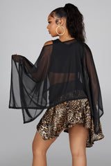 Sheer mesh poncho top with a wide boat neckline featuring asymmetrical 