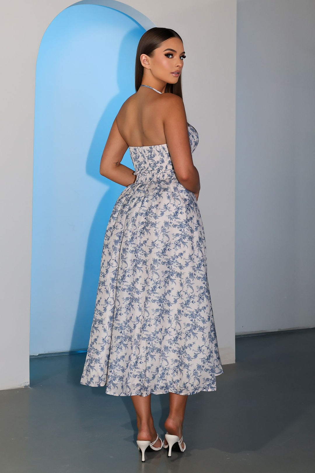 EDGE — white and blue floral toile print corset midi dress, back view on model looking over shoulder