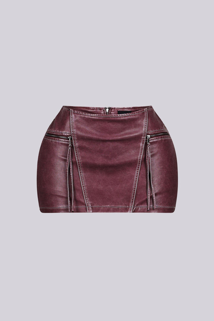 Faux leather low rise micro skirt with zip and tassel accenting on the sides featuring elasticized paneling at back