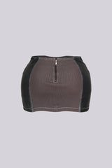 Faux leather low rise micro skirt with zip and tassel accenting on the sides featuring elasticized paneling at back