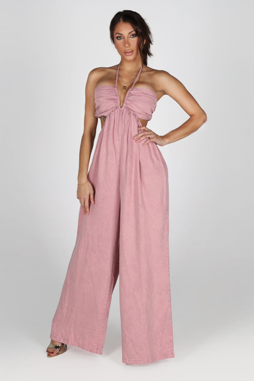 Sleeveless wide leg denim jumpsuit with a tie neck halter top
