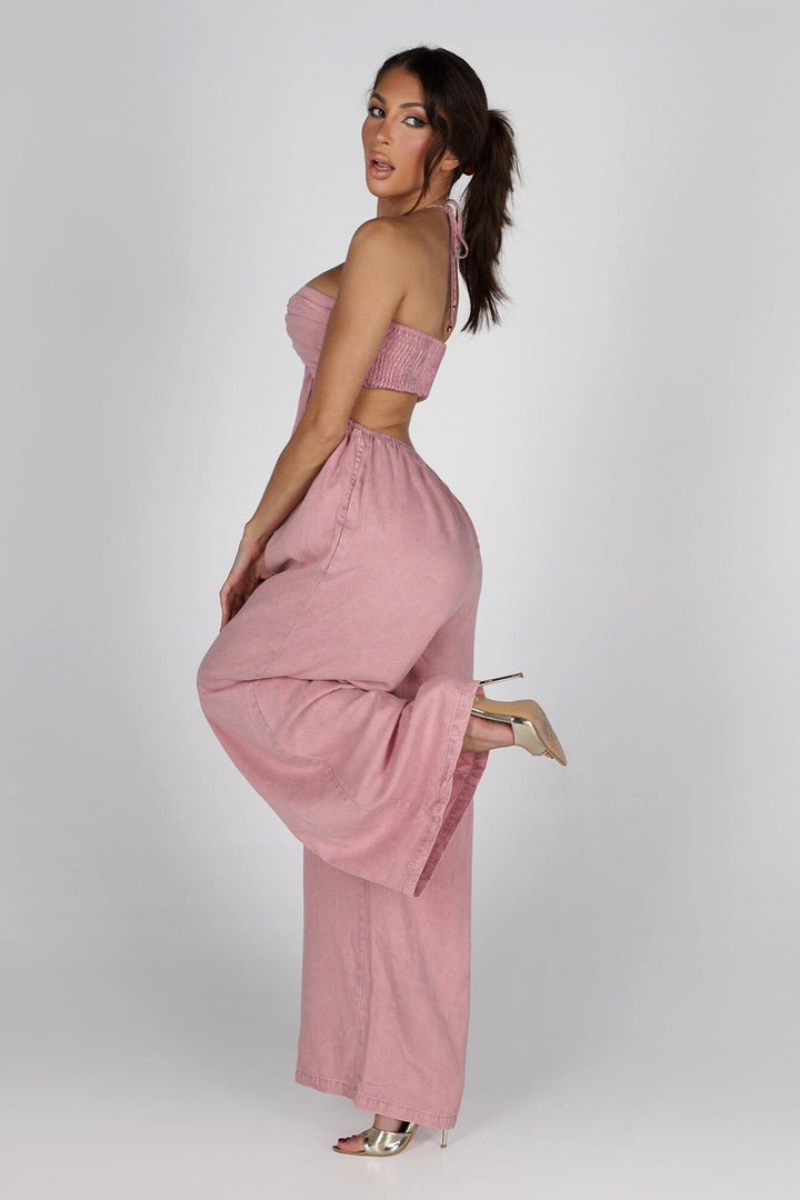 Sleeveless wide leg denim jumpsuit with a tie neck halter top