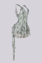 Deep plunging v neckline dress featuring double corset style lace-up detailing, Back side stretchy smocked center panel for contouring fit, Asymmetrical ruffle mini skirt with a ruffle sash hanging from one side