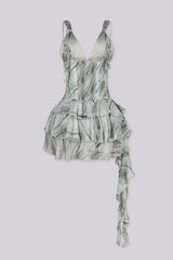 Deep plunging v neckline dress featuring double corset style lace-up detailing, Back side stretchy smocked center panel for contouring fit, Asymmetrical ruffle mini skirt with a ruffle sash hanging from one side