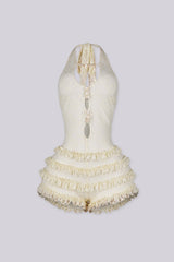 Fitted bodice halter romper with deep V neckline featuring vertical teardrop keyhole cutout and seashell beads embellishments
Micro mini shorts featuring overlaid with horizontal tiers of ruffle detailing