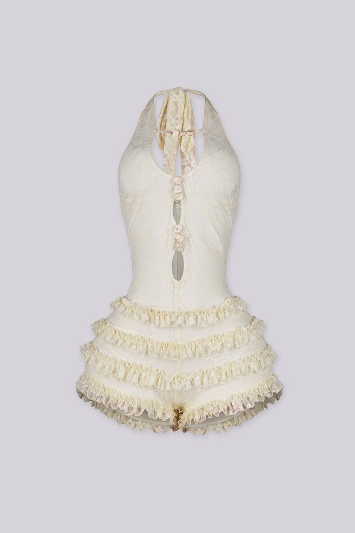 Fitted bodice halter romper with deep V neckline featuring vertical teardrop keyhole cutout and seashell beads embellishments
Micro mini shorts featuring overlaid with horizontal tiers of ruffle detailing