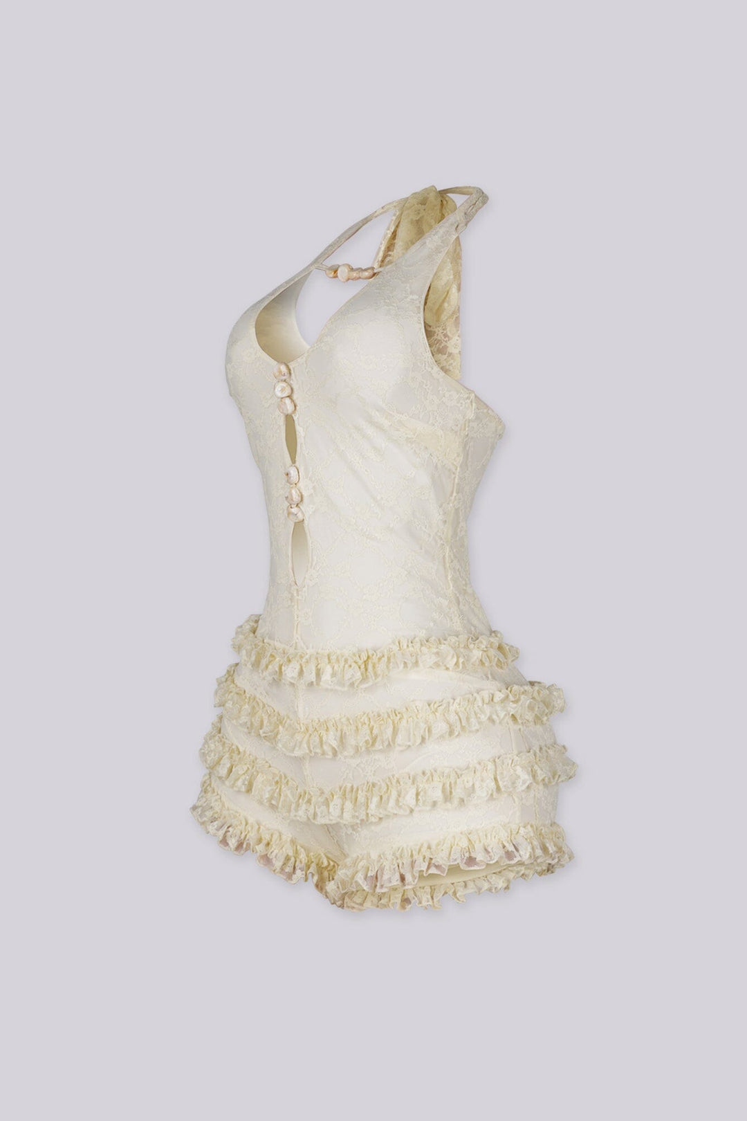 Fitted bodice halter romper with deep V neckline featuring vertical teardrop keyhole cutout and seashell beads embellishments
Micro mini shorts featuring overlaid with horizontal tiers of ruffle detailing