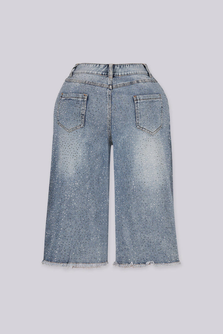 Wide denim bermuda shorts with frayed hem featuring rhinestone embellishments throughout&amp;nbsp;