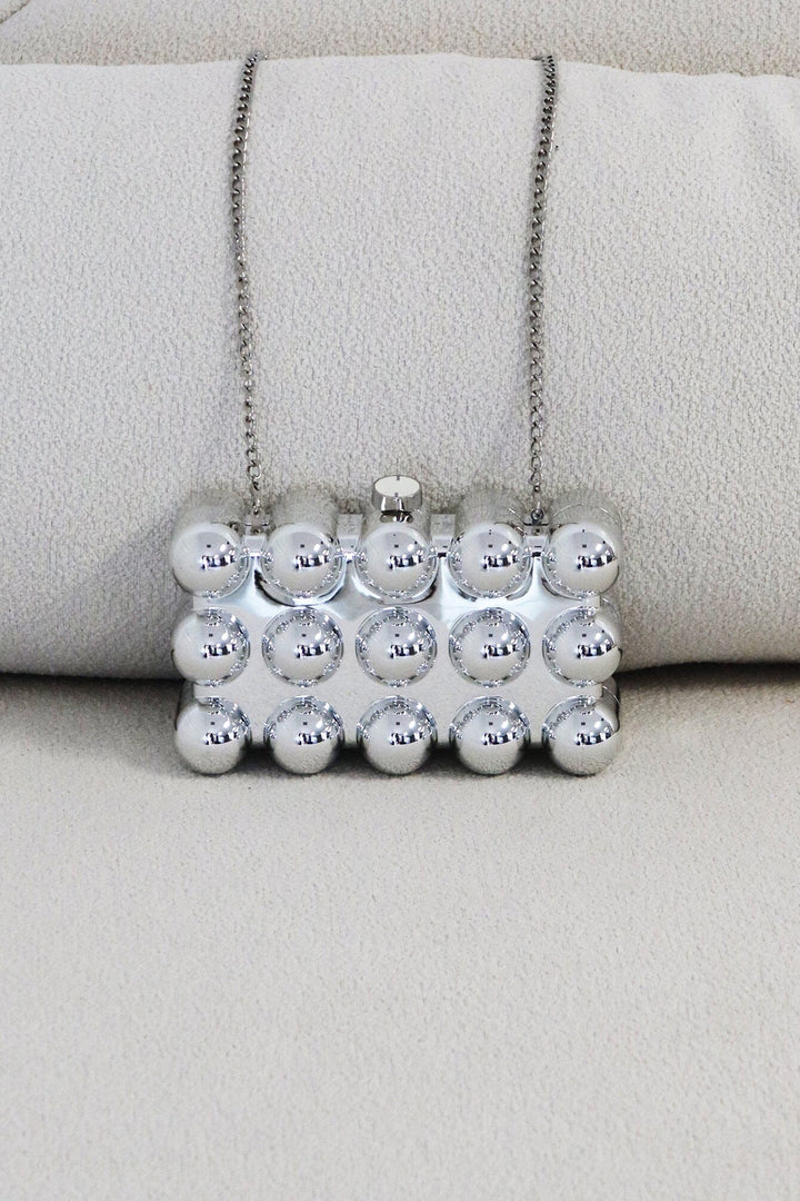 EDGE — silver bubble-textured mini clutch, front view flat lay