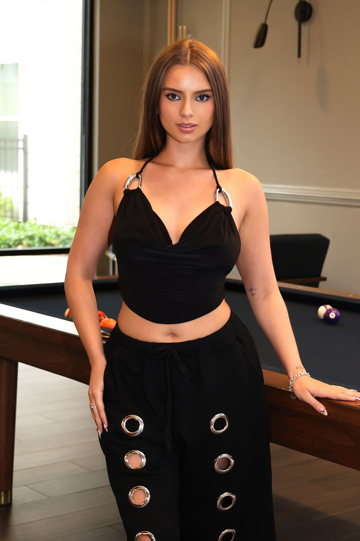 Halter top featuring draped cowl neckline with silver ring hardware, Open back style with ties at the nape and lower back