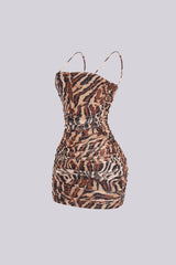 Mesh leopard print ruched mini dress featuring all over rhinestone embellishments