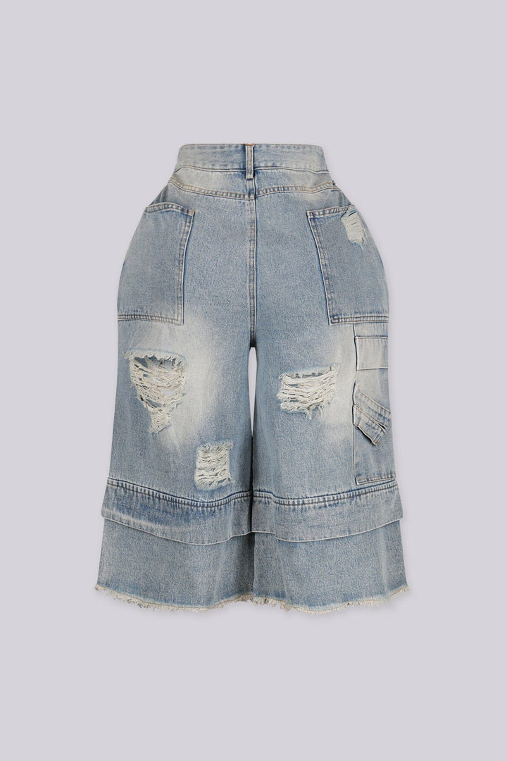 High rise wide leg bermuda denim shorts with distressed rips and frayed patches, back view
