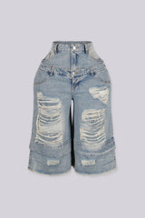 High rise wide leg bermuda denim shorts with distressed rips and frayed patches, front view