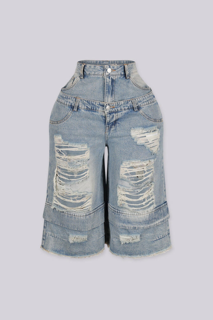 High rise wide leg bermuda denim shorts with distressed rips and frayed patches, front view