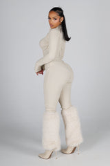 Sleek long sleeve ribbed knit jumpsuit featuring precision stitching and zippered leg details