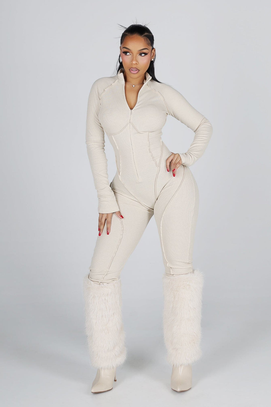 Sleek long sleeve ribbed knit jumpsuit featuring precision stitching and zippered leg details