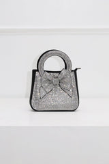 EDGE — black rhinestone bow-embellished top-handle mini clutch, front view flat lay