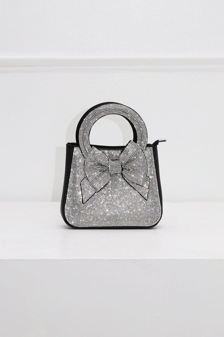 EDGE — black rhinestone bow-embellished top-handle mini clutch, front view flat lay