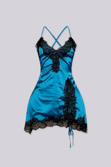 Satin fitted mini slip dress with spaghetti straps featuring lace applique along the bodice and asymmetrical hem