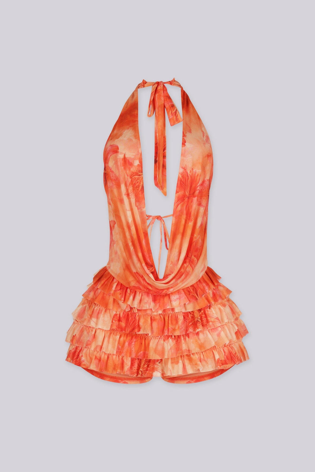 Orange floral romper featuring a halter top and tiered ruffle detailing,
Open back with self-tie closure