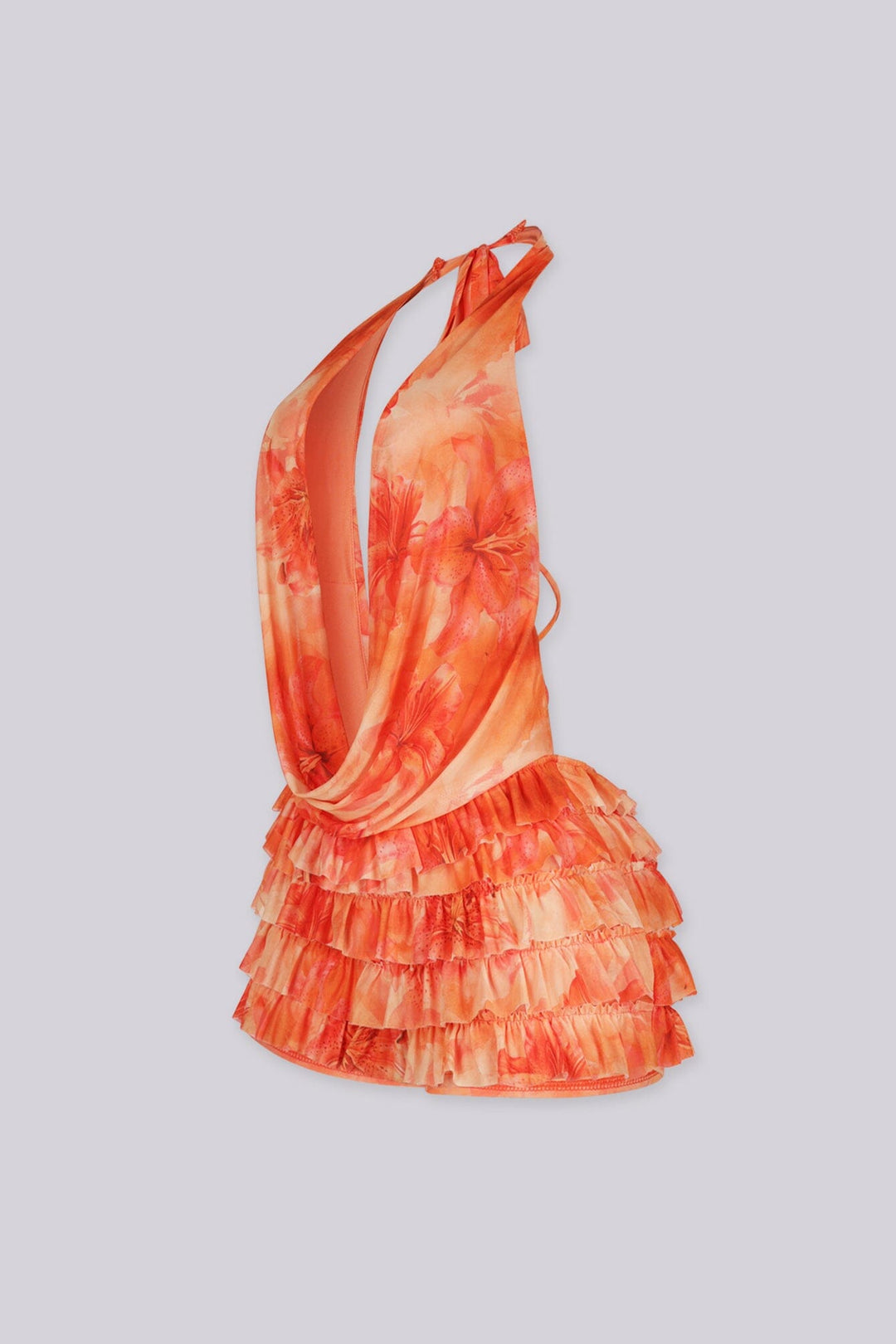 Orange floral romper featuring a halter top and tiered ruffle detailing,
Open back with self-tie closure