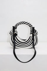 EDGE — black and white striped half-moon bag with detachable shoulder strap, flat lay