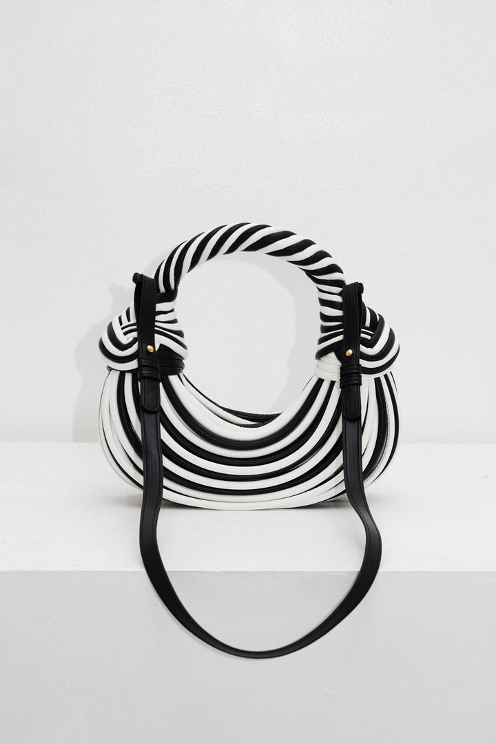 EDGE — black and white striped half-moon bag with detachable shoulder strap, flat lay