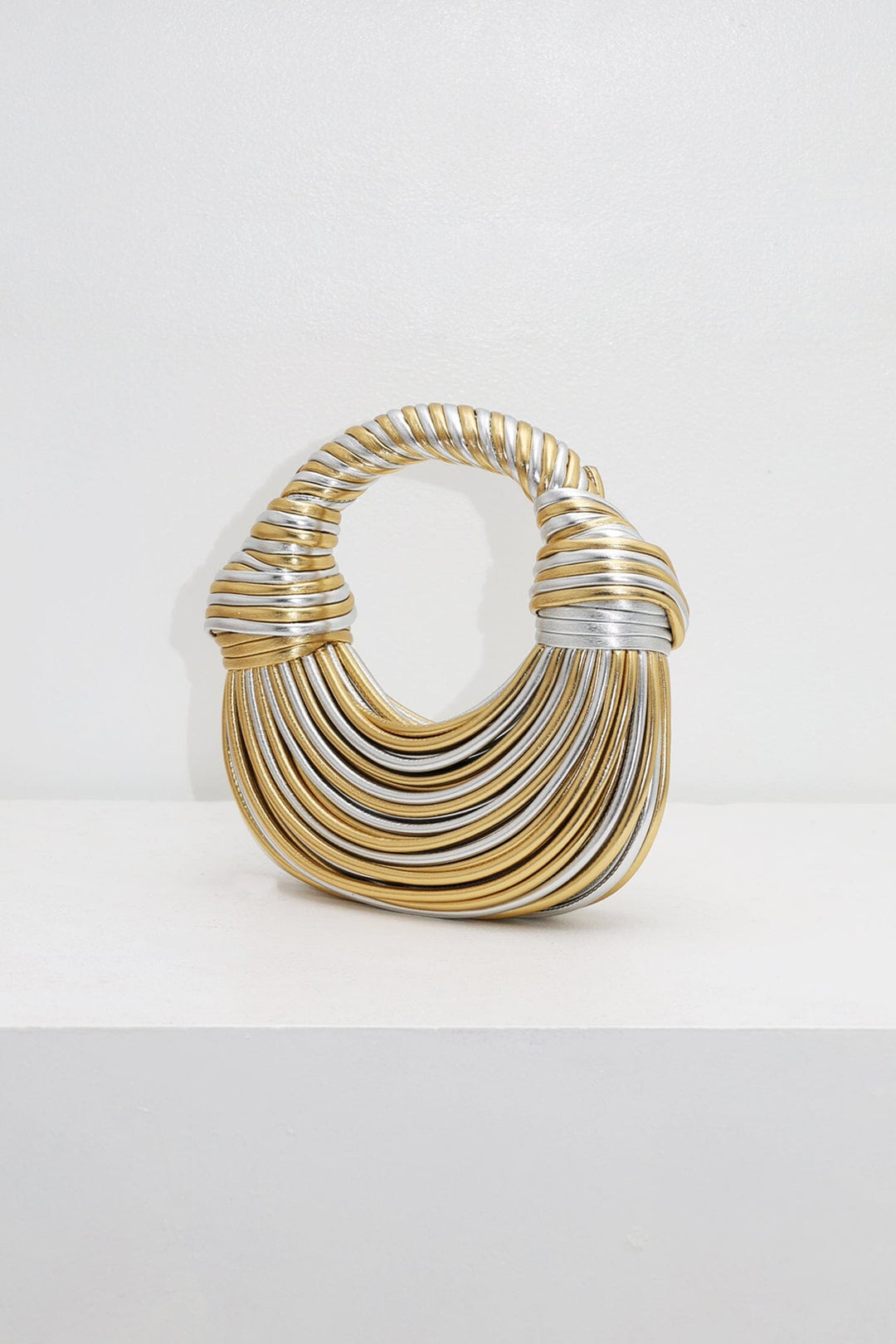 EDGE — gold and silver ribbed half-moon top-handle bag, front view flat lay